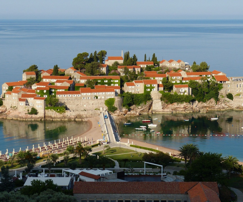 A red-roofed island village and Adriatic coastal scenery on the Montenegro and Croatia trip.